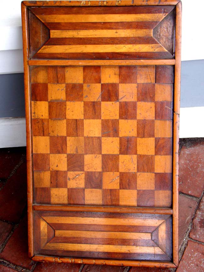 A beautiful 19th century fruitwood inlaid walnut games board on carved base circa 1870